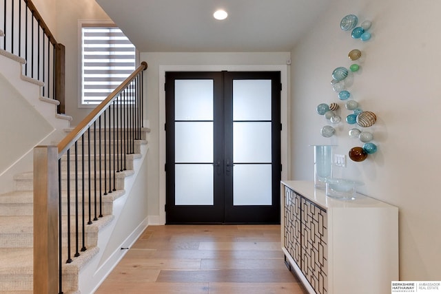 entrance foyer with light wood-type flooring and french doors