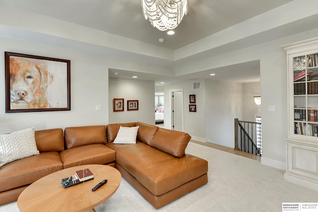 living room with carpet and a chandelier