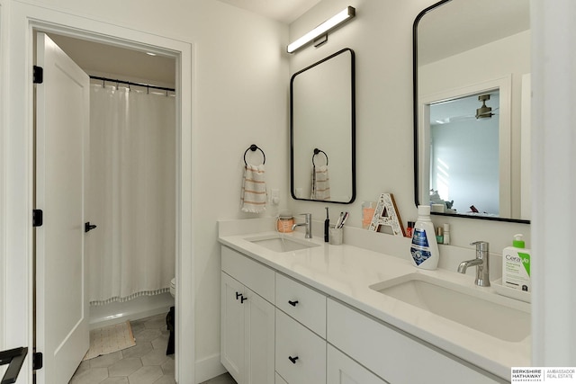 full bathroom featuring vanity, tile patterned floors, toilet, and shower / tub combo with curtain