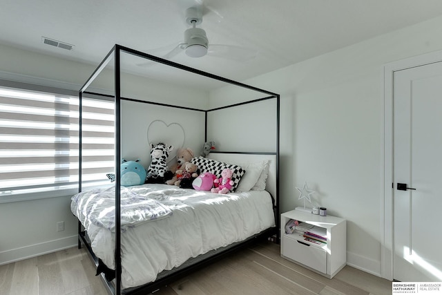 bedroom with ceiling fan and light wood-type flooring