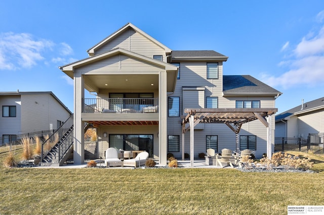 back of property featuring a balcony, a yard, a pergola, and a patio area