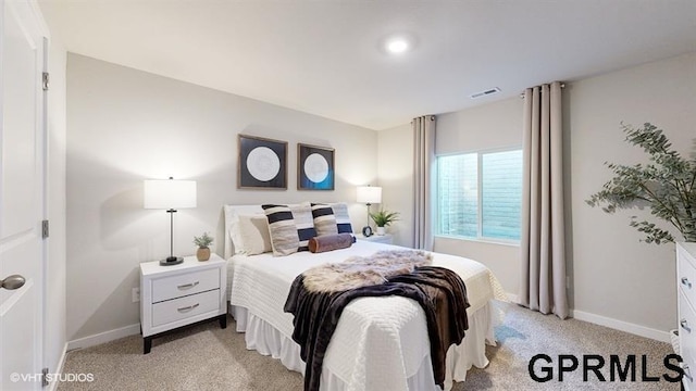 bedroom featuring light colored carpet