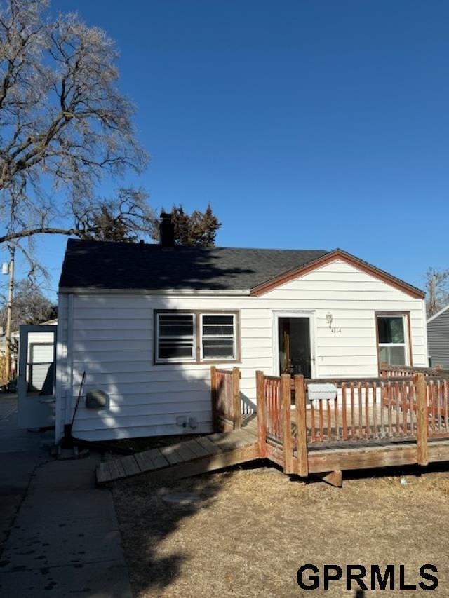 rear view of house with a wooden deck