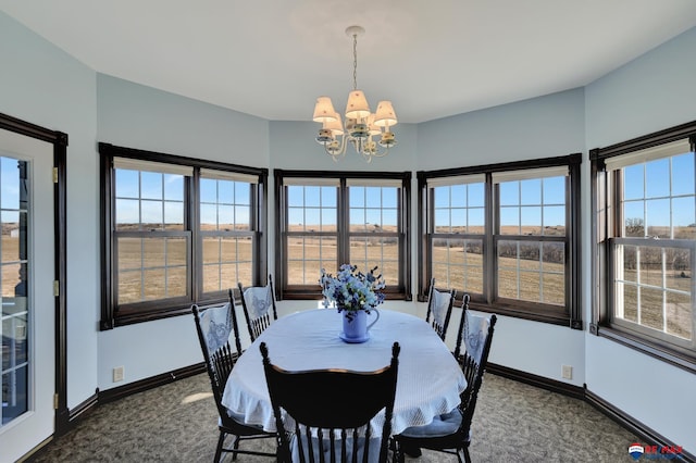 dining space with baseboards, dark carpet, and a notable chandelier