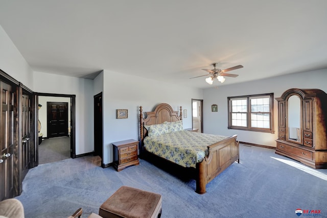 bedroom with dark colored carpet, a ceiling fan, and baseboards