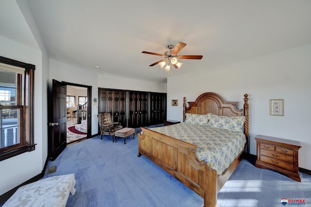 carpeted bedroom with a ceiling fan and baseboards