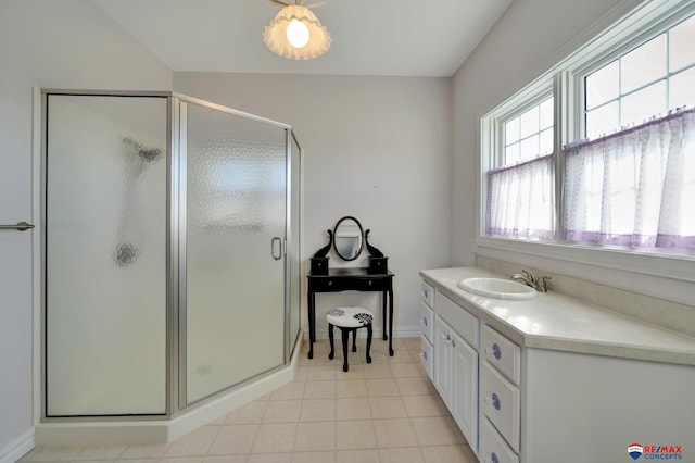 bathroom with tile patterned flooring, baseboards, vanity, and a shower stall