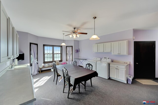 dining area featuring light carpet, ceiling fan, and washing machine and clothes dryer