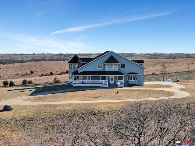 view of front of property featuring a rural view and a front yard