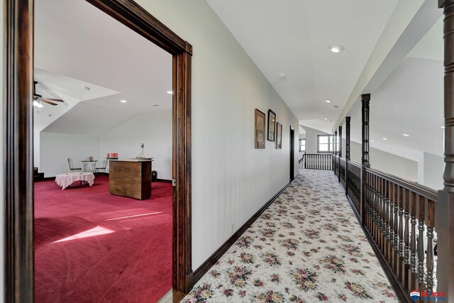 hall featuring carpet floors, ornate columns, recessed lighting, and lofted ceiling