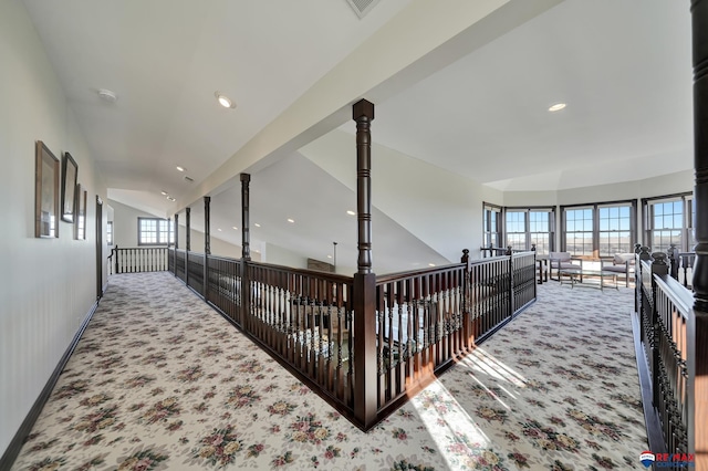 corridor featuring baseboards, recessed lighting, visible vents, and light colored carpet