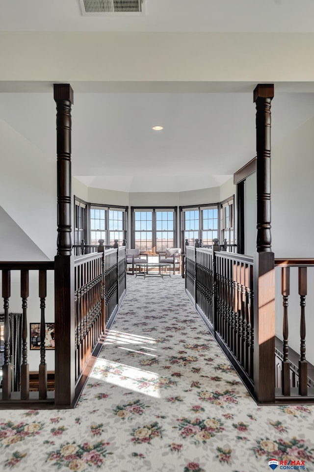 hallway with carpet floors, visible vents, and recessed lighting