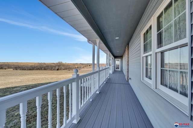 wooden terrace featuring a rural view