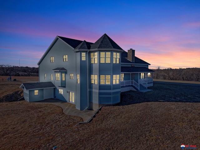 view of front of home featuring a porch and a chimney