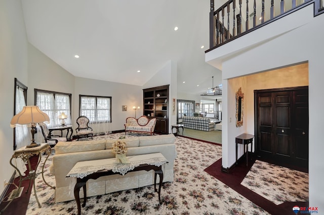 living room with a high ceiling, baseboards, and recessed lighting