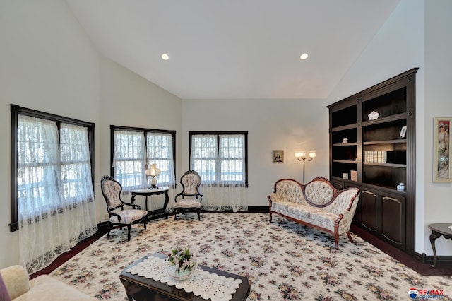 living area featuring high vaulted ceiling, dark colored carpet, and recessed lighting