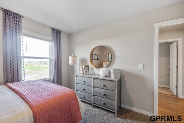 bedroom featuring light carpet