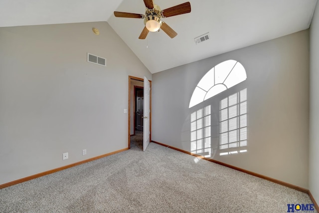 carpeted empty room with ceiling fan and high vaulted ceiling