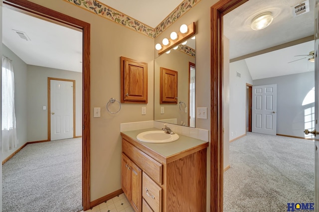 bathroom featuring ceiling fan, lofted ceiling, and vanity