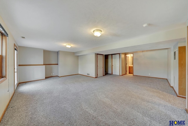 empty room featuring carpet floors and a textured ceiling