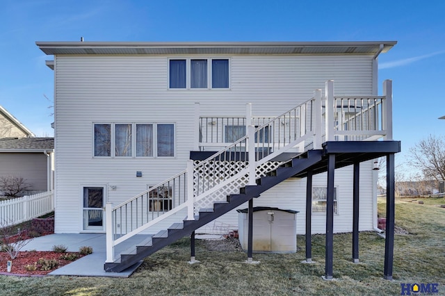 back of house with a yard and a patio