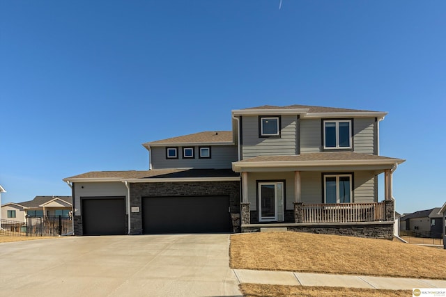 view of front of house featuring a garage and a porch