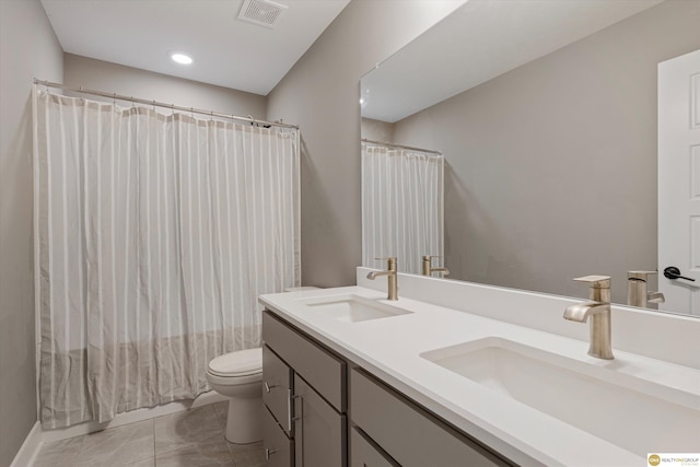 bathroom featuring vanity, tile patterned floors, toilet, and walk in shower