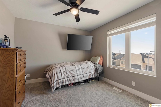 bedroom featuring ceiling fan and carpet