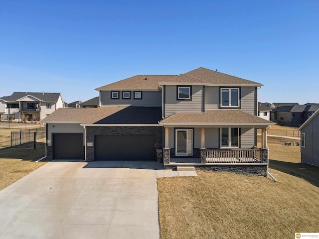 view of front of house with a porch, a garage, and a front yard