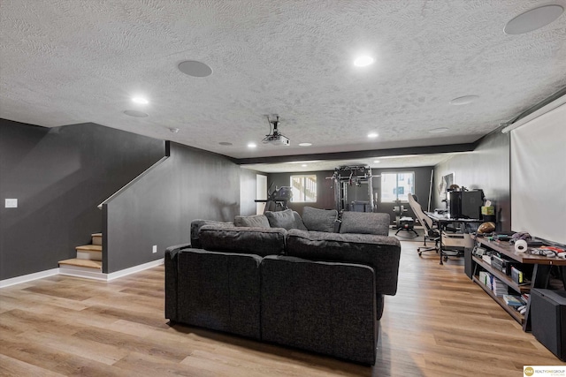 living room with light hardwood / wood-style floors and a textured ceiling