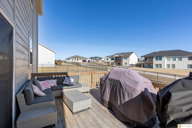 wooden deck with an outdoor living space and grilling area