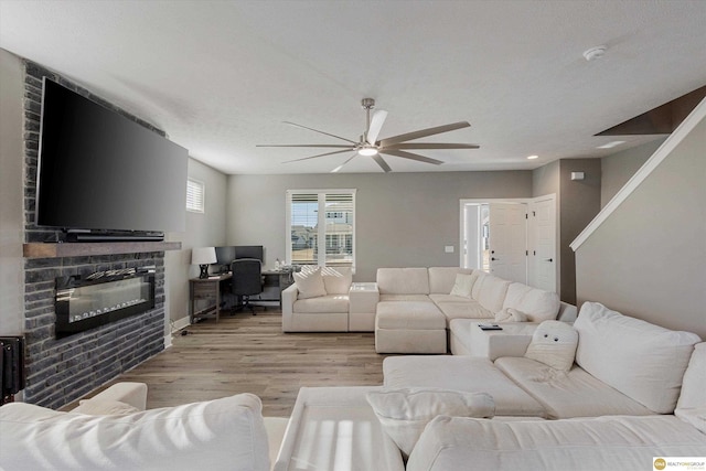 living room with ceiling fan and light wood-type flooring