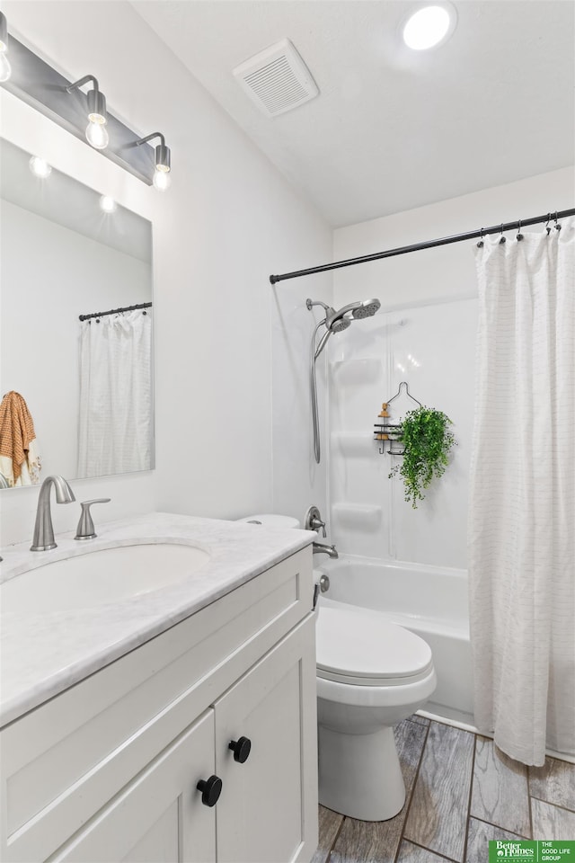 full bathroom featuring shower / tub combo with curtain, vanity, and toilet