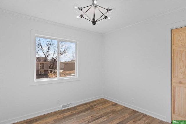 unfurnished dining area featuring a notable chandelier, crown molding, and hardwood / wood-style floors