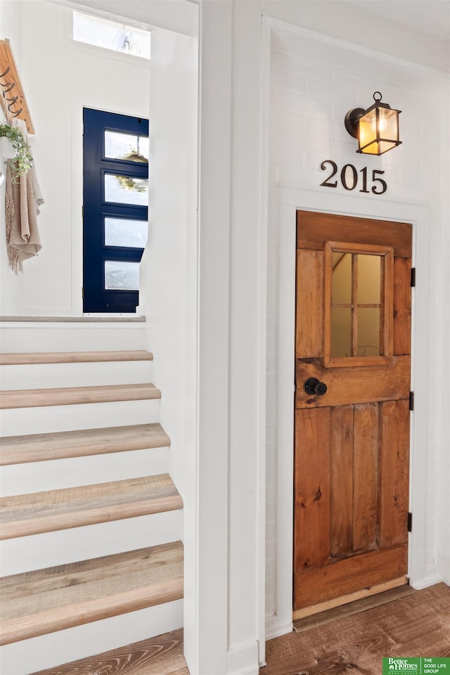 stairway with hardwood / wood-style flooring