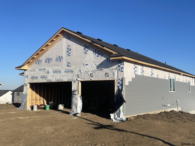 view of side of property with a garage