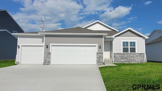 view of front of home featuring a garage and a front lawn