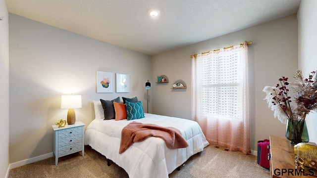 carpeted bedroom featuring a textured ceiling