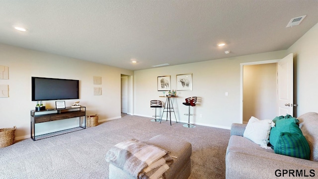 carpeted living room with a textured ceiling