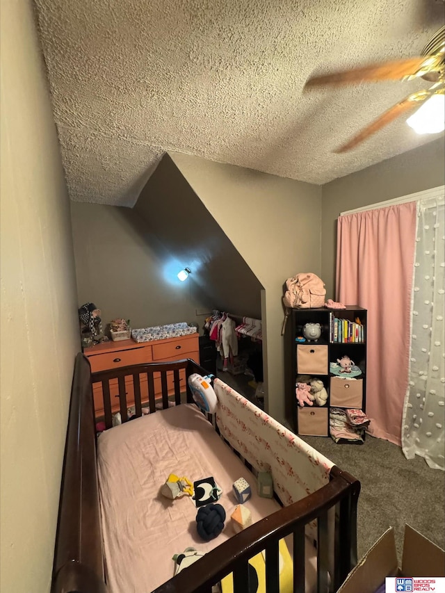 carpeted bedroom with ceiling fan and a textured ceiling