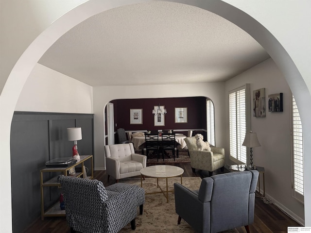 living room with dark hardwood / wood-style flooring and a textured ceiling