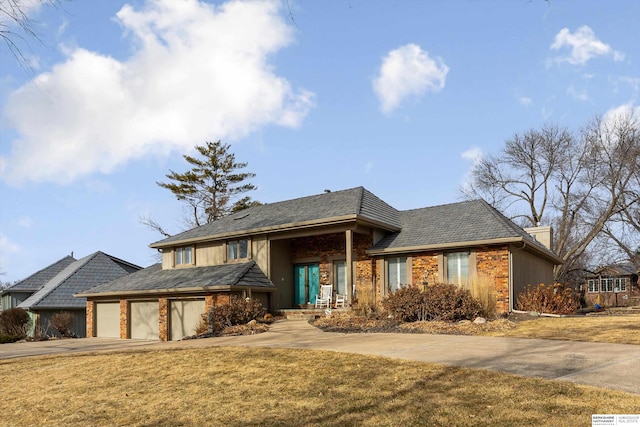 view of front of property with a garage and a front lawn