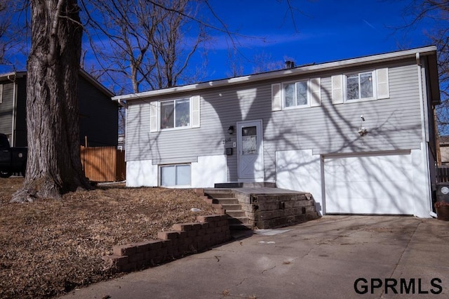 rear view of house featuring a garage