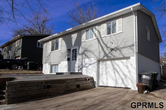 rear view of house with a garage