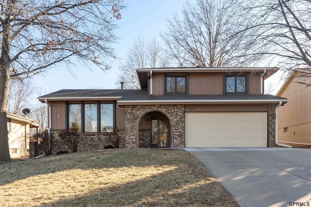 view of front of house with a garage and a front yard