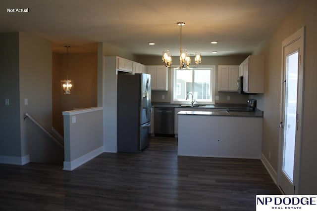 kitchen featuring appliances with stainless steel finishes, a notable chandelier, white cabinets, dark hardwood / wood-style flooring, and decorative light fixtures