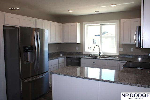 kitchen with appliances with stainless steel finishes, sink, and white cabinets