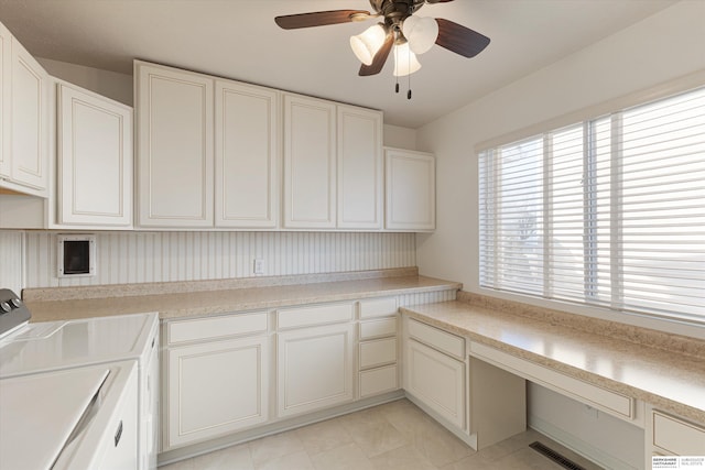 laundry room with light tile patterned floors, washing machine and dryer, cabinets, and ceiling fan