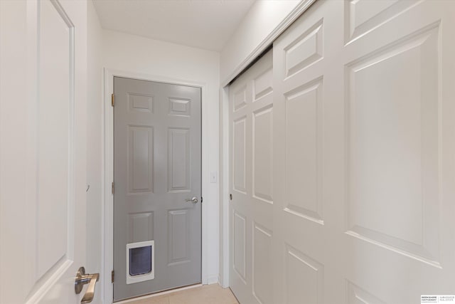 corridor featuring light tile patterned flooring