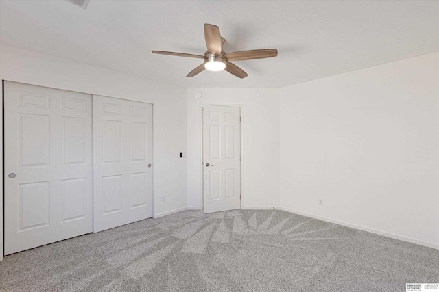 unfurnished bedroom featuring carpet floors, ceiling fan, and a closet